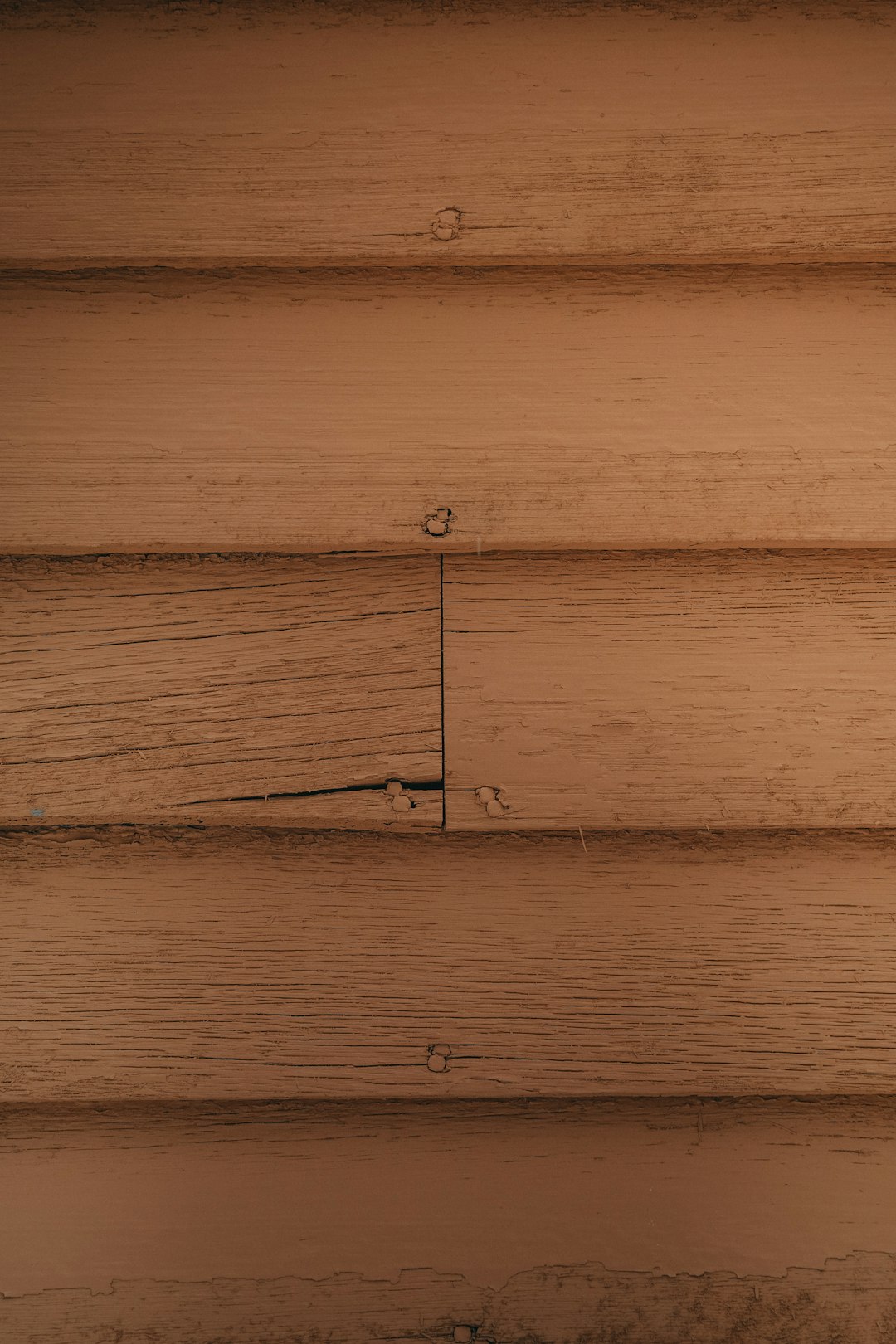 Photorealistic close-up of the wood texture on an old cabin wall, warm tones, low angle view, simple, minimalist, symmetrical. –ar 85:128