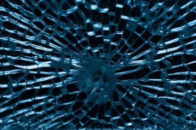 shattered glass, blue background, close up, symmetrical, sharp focus, high resolution photography --ar 128:85