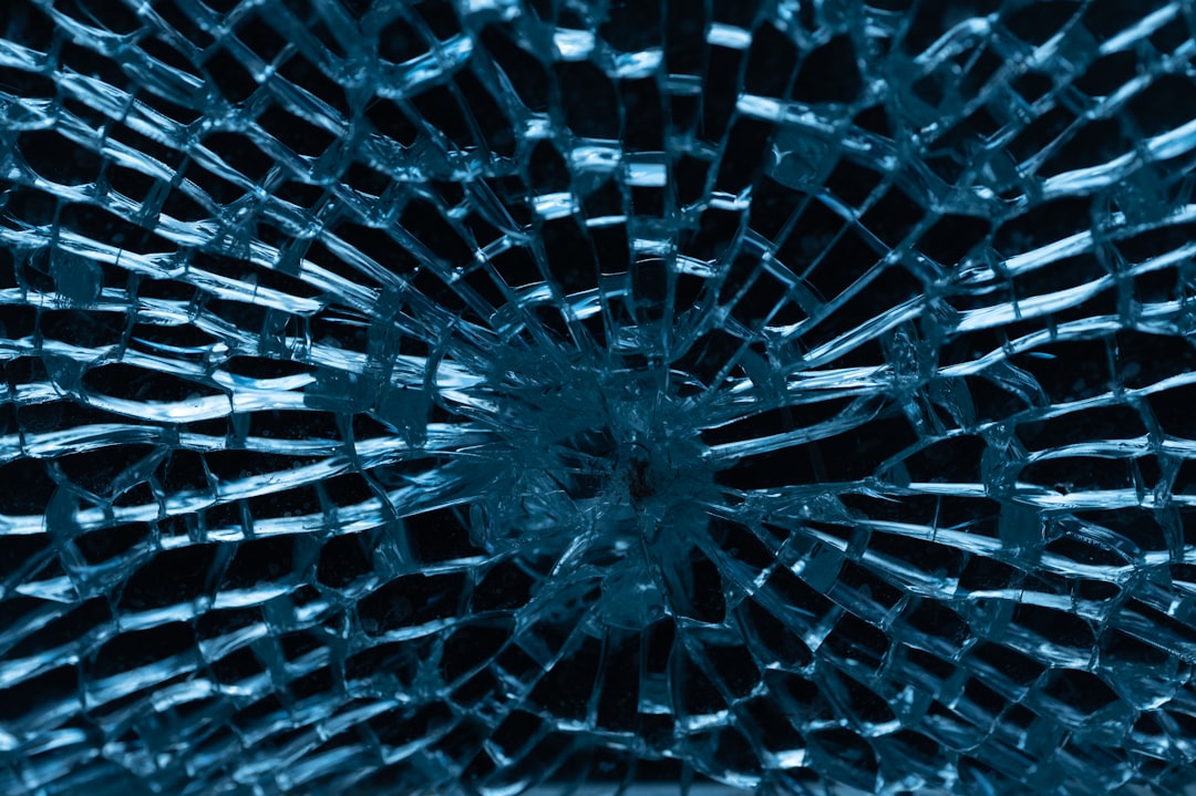 shattered glass, blue background, close up, symmetrical, sharp focus, high resolution photography –ar 128:85