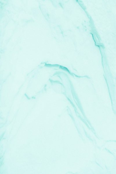 A close up of an ice background with a light blue, mint green and white color palette, in a pastel aesthetic style, with flat lay photography on a minimalist background, with a high resolution. --ar 85:128