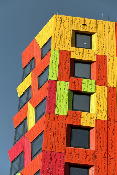 A tall building made of colorful panels with the letter "B" on each panel, in the style of architectural photography, high resolution. --ar 85:128