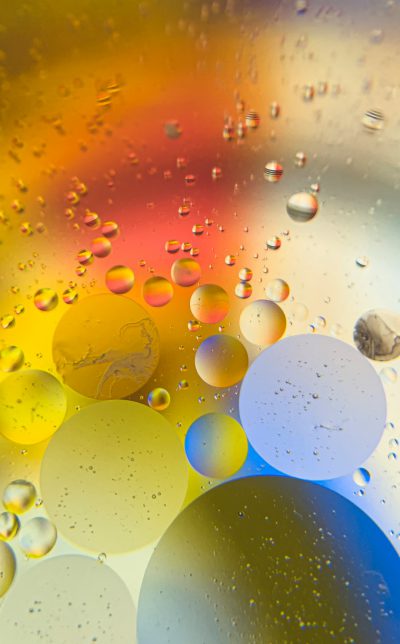 abstract colorful background with bubbles and oil in water, yellow blue red green, round shapes, photo taken by Canon EOS R6 Mark II Mirrorless , wide angle shot --ar 79:128