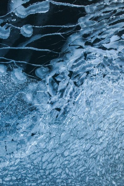 top view of cracked ice on lake, abstract photography, aerial, fujifilm pro 400h --ar 85:128