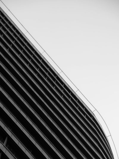 black and white photo of a curved building, architectural photography, building facade closeup shot, high angle, taken with a Fujifilm X-T4 camera. --ar 3:4