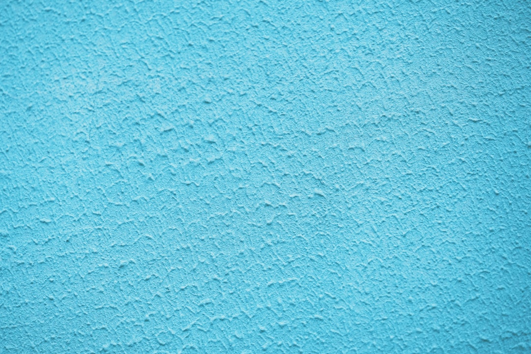 Light blue plaster wall background, closeup, high resolution photography, high quality photo –ar 128:85