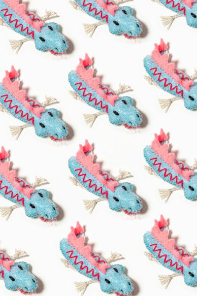 A pattern of felted Chinese dragons, in pink and blue colors, white background, flat lay, seamless wallpaper --ar 85:128