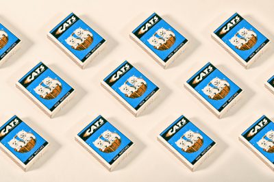 A grid of white match boxes with the word "CATS" printed on them, each containing one blue and brown cat-shaped cigarette match, arranged in rows against a pure background. The illustrations feature cats depicted as pet toys or accessories, showcasing playful poses, and include subtle details like fur textures to enhance realism. This design is for an advertising campaign that celebrates casual moments between friends and their feline companions, in the style of playful pet illustrations. --ar 128:85