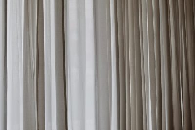 Photo of gray curtains, closeup, blurred background, light beige and white colors, high resolution photography, soft focus --ar 128:85