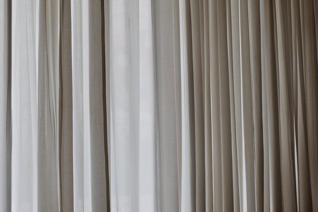 Photo of gray curtains, closeup, blurred background, light beige and white colors, high resolution photography, soft focus –ar 128:85