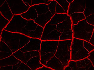 Red glowing cracks on black background, abstract texture for design and decoration. --ar 4:3