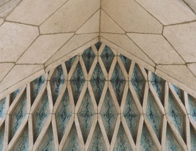 A closeup shot of the architecture detail, showcasing intricate geometric patterns on stone and ceramic tiles in pastel blue hues. The perspective is from an elevated angle, capturing the symmetrical arrangement of these elements that form delicate diamond shapes with perfect symmetry across the arches. This detailed photograph highlights the beauty and complexity found within architectural design. Shot in the style of Alex CTYRINAS using a Sony Alpha A7 III camera with a FE24mm F/5 G lens at an f/8 aperture setting, at ultra high definition. --ar 64:49