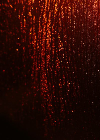 Red glitter background, red rain drops on the glass, dark red and orange tones, depth of field, blurred light spots, closeup, photography style, ultrahigh definition resolution. --ar 91:128