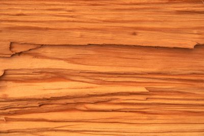 High resolution photo of an old wood wall with cracks and wood grain in the style of Diorama, featuring peach colored wood planks. The focus is on the texture of each wooden surface, capturing its natural beauty. This closeup view highlights every line and ageold marks that give it character. Soft lighting creates gentle shadows to enhance details. --ar 128:85