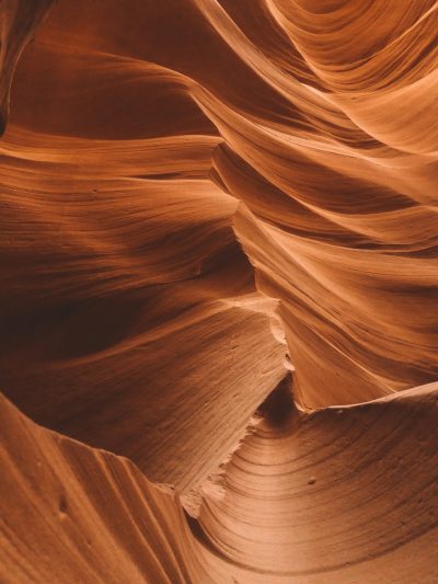 A closeup shot of the intricate patterns in Antelope Canyon, showcasing its unique rock formations and natural beauty. The warm tones of orange and brown create an inviting atmosphere that makes it feel like you're right there. This photo will be perfect for adding a touch of mystery to your Instagram post in the style of nature photography! --ar 3:4