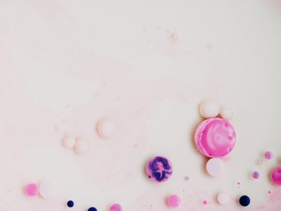 White background with pink and purple bubbles scattered around, small macarons, minimalistic design with negative space, high resolution photographic style. --ar 4:3