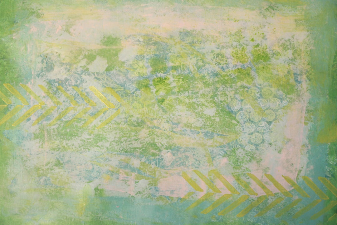 a soft, gentle, dreamy background with a chevron pattern in light green and yellow. The painting has an abstract feel to it with a palette of greens, blues, pinks, yellows, and white. There is lots of negative space throughout the artwork. –ar 128:85