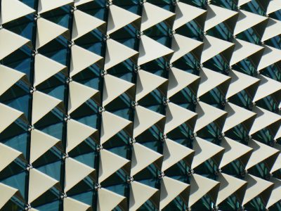 A closeup shot of the building facade featuring triangular metal tiles arranged in an angular pattern, creating geometric designs on its exterior walls., architectural photography, ultra wide angle lens, high resolution, high detail --ar 4:3