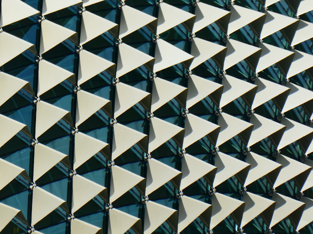 A closeup shot of the building facade featuring triangular metal tiles arranged in an angular pattern, creating geometric designs on its exterior walls., architectural photography, ultra wide angle lens, high resolution, high detail –ar 4:3