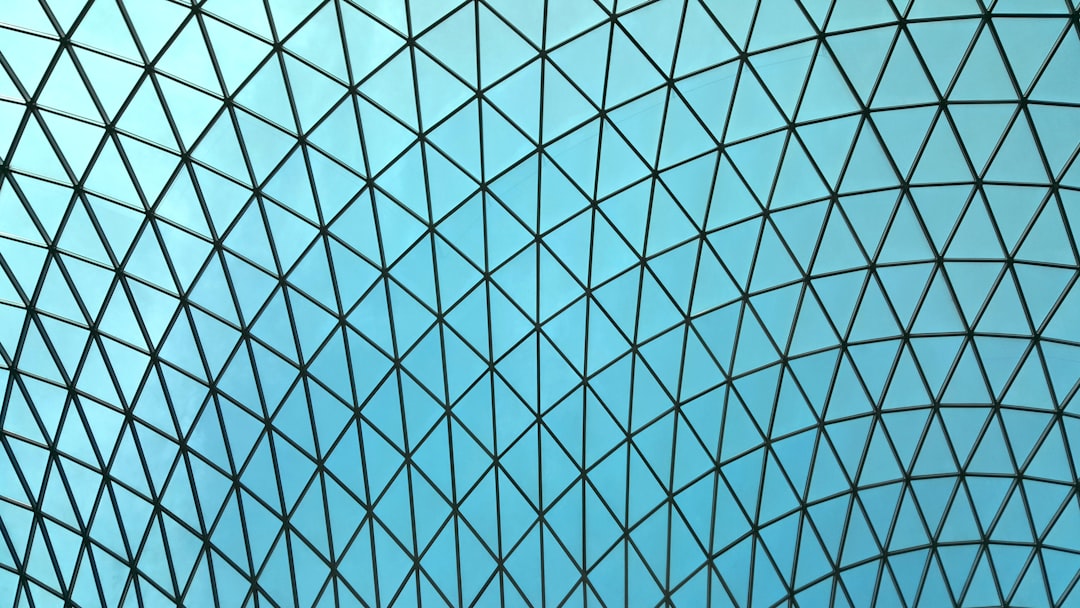 A geometric pattern of black lines on blue sky background, designed by architect [Jean Nouvel](https://goo.gl/search?artist%20Jean%20Nouvel) in the B.outside glass dome museum at The British Museum. High resolution photography –ar 16:9