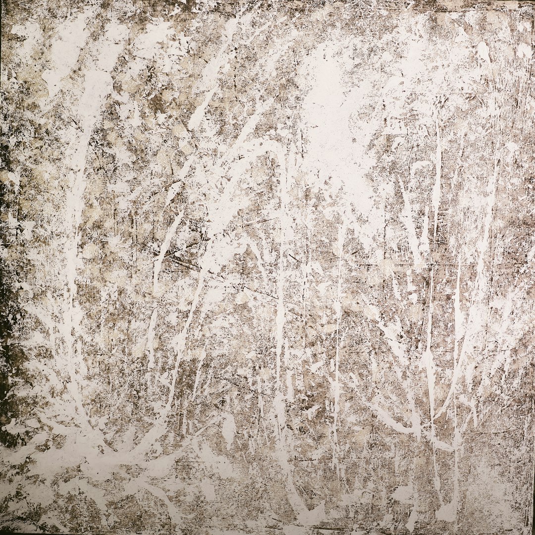 A distressed grunge background with a white color palette, textured surface, splattered paint, paint streaks, painted grasses and trees in the style of various artists.