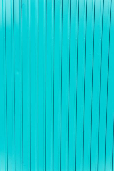 Close up of a blue turquoise metal wall background with vertical lines. The image is in the style of vertical lines. --ar 85:128