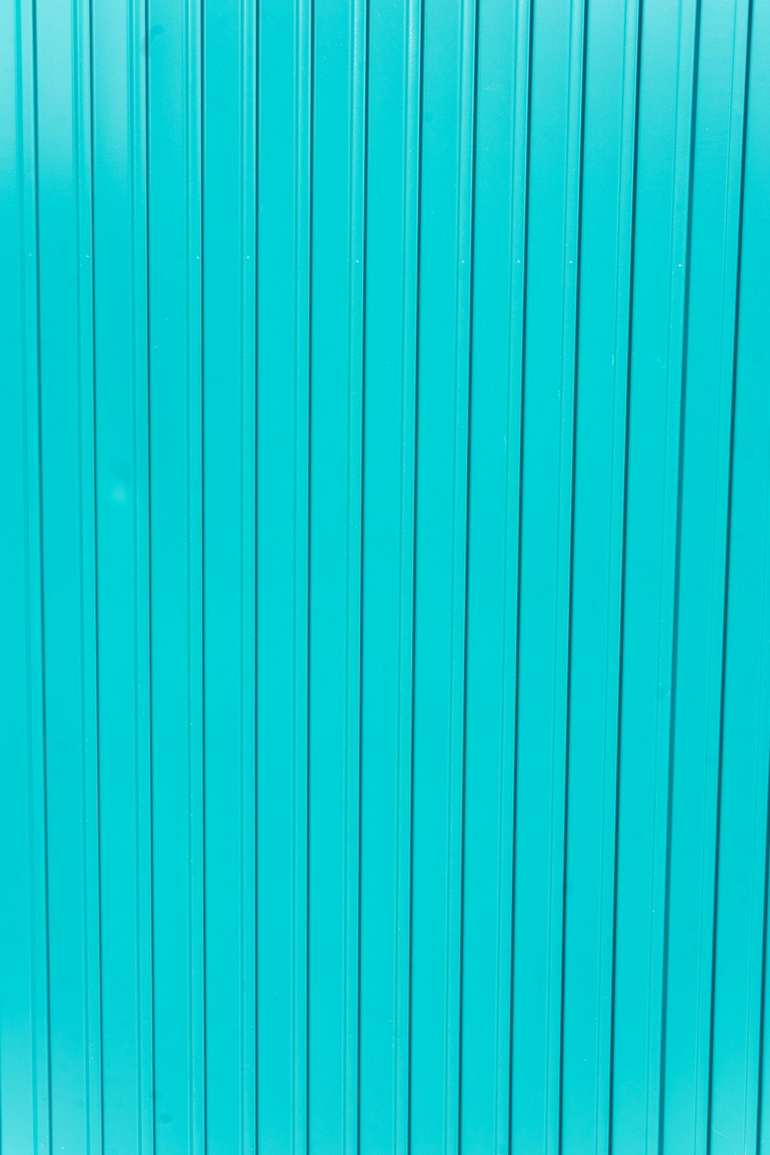 Close up of a blue turquoise metal wall background with vertical lines. The image is in the style of vertical lines. –ar 85:128