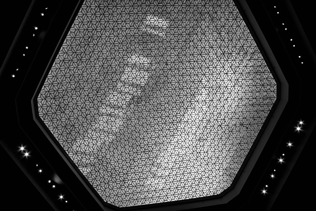 3d render of ceiling with hexagon pattern, black and white, metallic silver texture, light reflection on the surface, stars in background, high resolution, intricate details, symmetrical composition, professional photography lighting, shot using Sony Alpha A7 III camera with FE 2490mm f/4 P Douache lens –ar 128:85