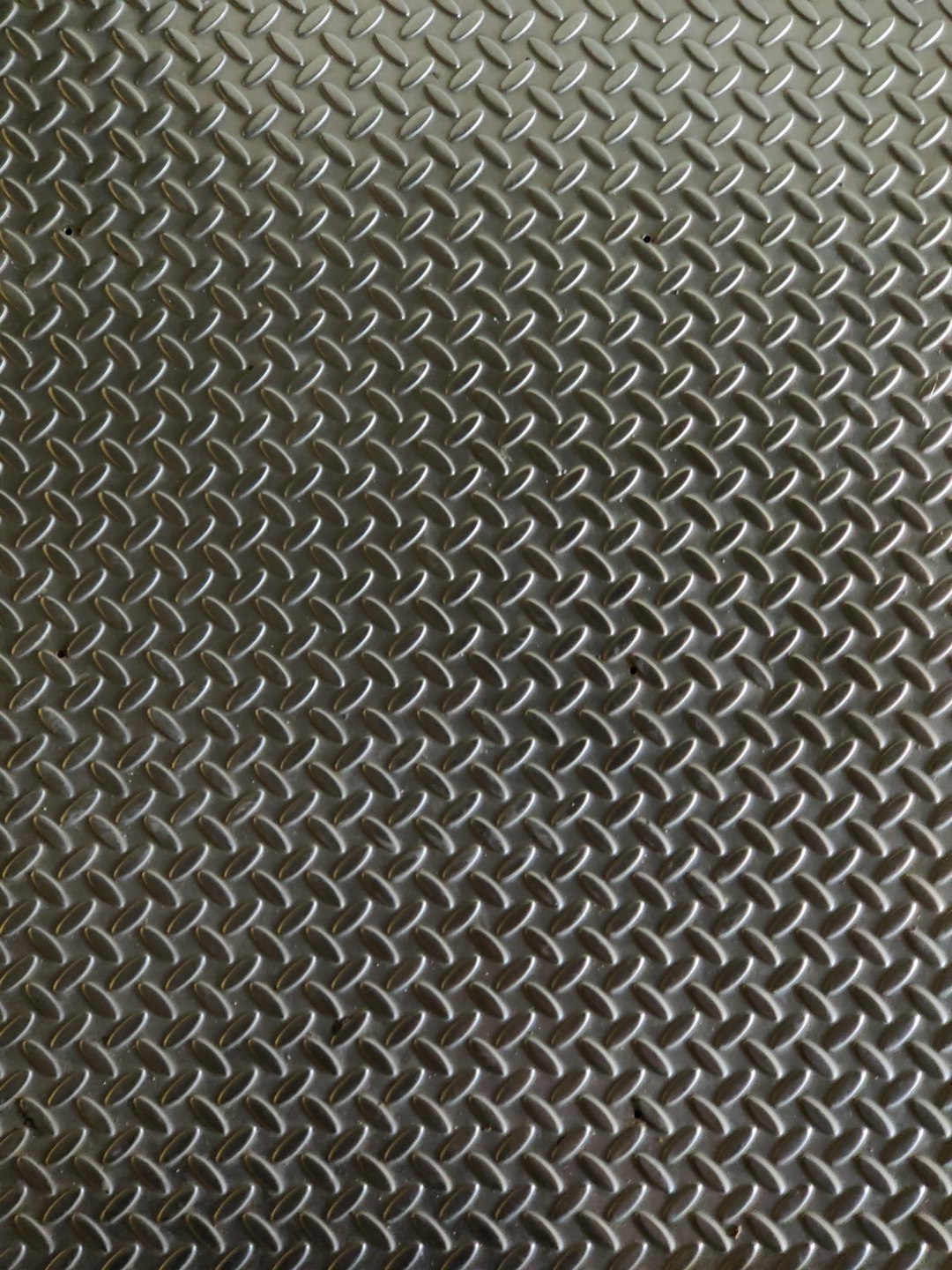 A closeup of the diamond plate texture, showcasing its intricate pattern and shiny surface, perfect for creating industrialthemed designs or backgrounds. The background is dark grey with a textured look that adds depth to your design projects. This stock photo highlights one side of each diamond plate element, making it ideal as an RPG game background. –ar 3:4