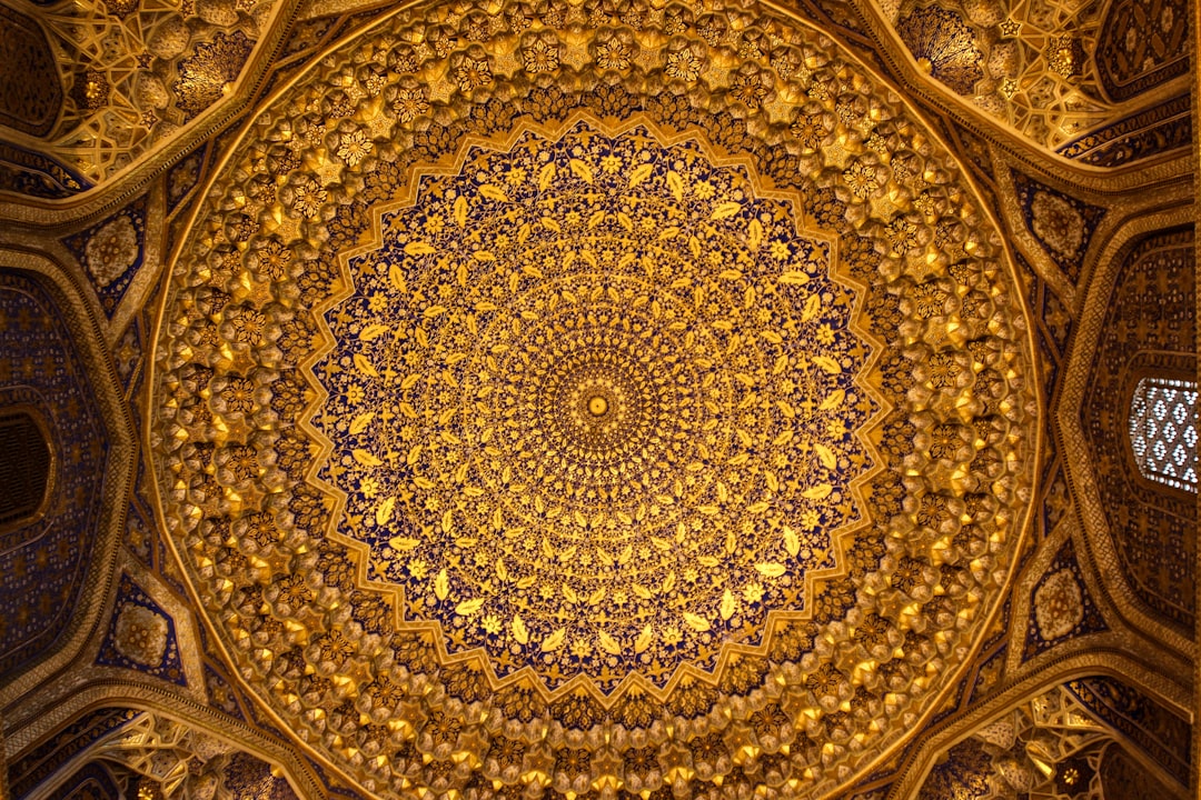 The golden dome of the Grand hall in Samarkand, with Persian and Turkish patterns on it, a huge golden mandala in the center of the ceiling, in the style of oriental art, the photo taken with Provia film. –ar 128:85