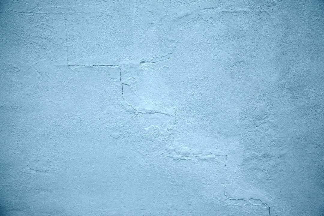 Light blue wall background, simple, with small cracks and worn edges, high resolution, high quality –ar 128:85