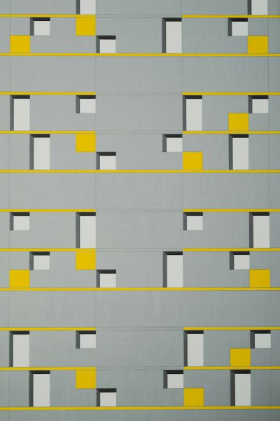 A grey and yellow wall with squares, by Ivan Chermayeff style --ar 85:128