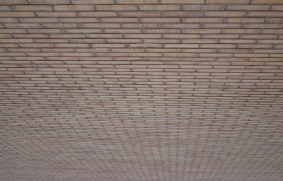 A photograph of the ceiling of an outdoor building, showing off its flat and horizontal brick texture. The bricks arranged in straight lines creating an endless pattern that stretches across the entire space. Soft lighting highlights their natural earthy tones. --ar 128:81