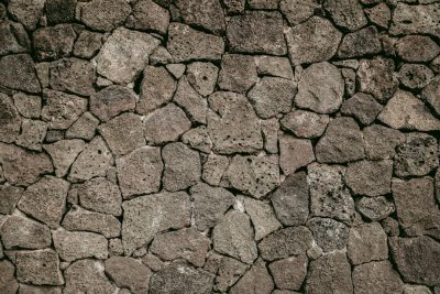 Flat lay of cracked lava stone wall texture background. Background for design, decoration and interior in brown tones. . , full depth of field in focus , cinematic shot on arri alexa cinema camera, macro lens --ar 128:85