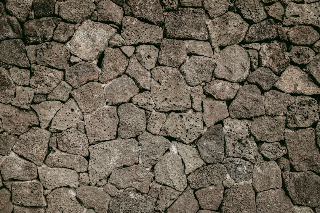 Flat lay of cracked lava stone wall texture background. Background for design, decoration and interior in brown tones. . , full depth of field in focus , cinematic shot on arri alexa cinema camera, macro lens –ar 128:85