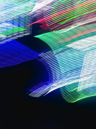 A photo of an abstract composition with lines and shapes in blue, green, white, and red colors on a black background. The lights create long exposure effects that highlight the dynamic movement and energy associated with light painting photography. Abstract photography in the style of light painting. --ar 95:128