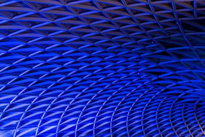 The ceiling of King's Cross Station in London, featuring the iconic blue triangular pattern that is seen on all tube stations. The ceiling is depicted in the documentary photography style with an ultra realistic photo and cinematic light. --ar 128:85