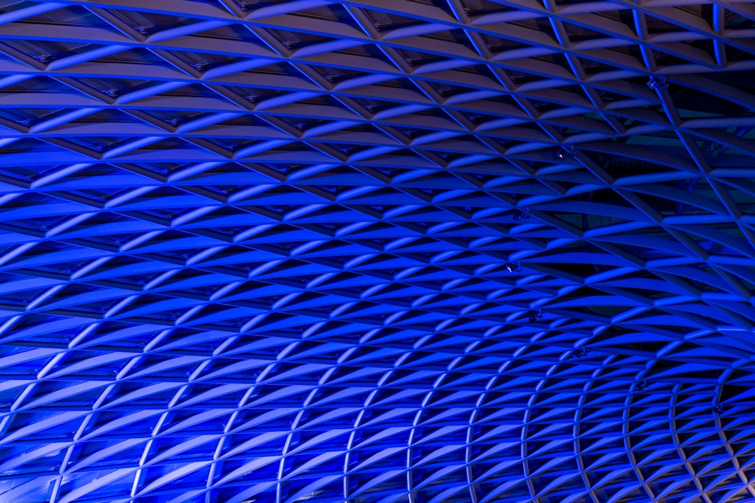 The ceiling of King’s Cross Station in London, featuring the iconic blue triangular pattern that is seen on all tube stations. The ceiling is depicted in the documentary photography style with an ultra realistic photo and cinematic light. –ar 128:85