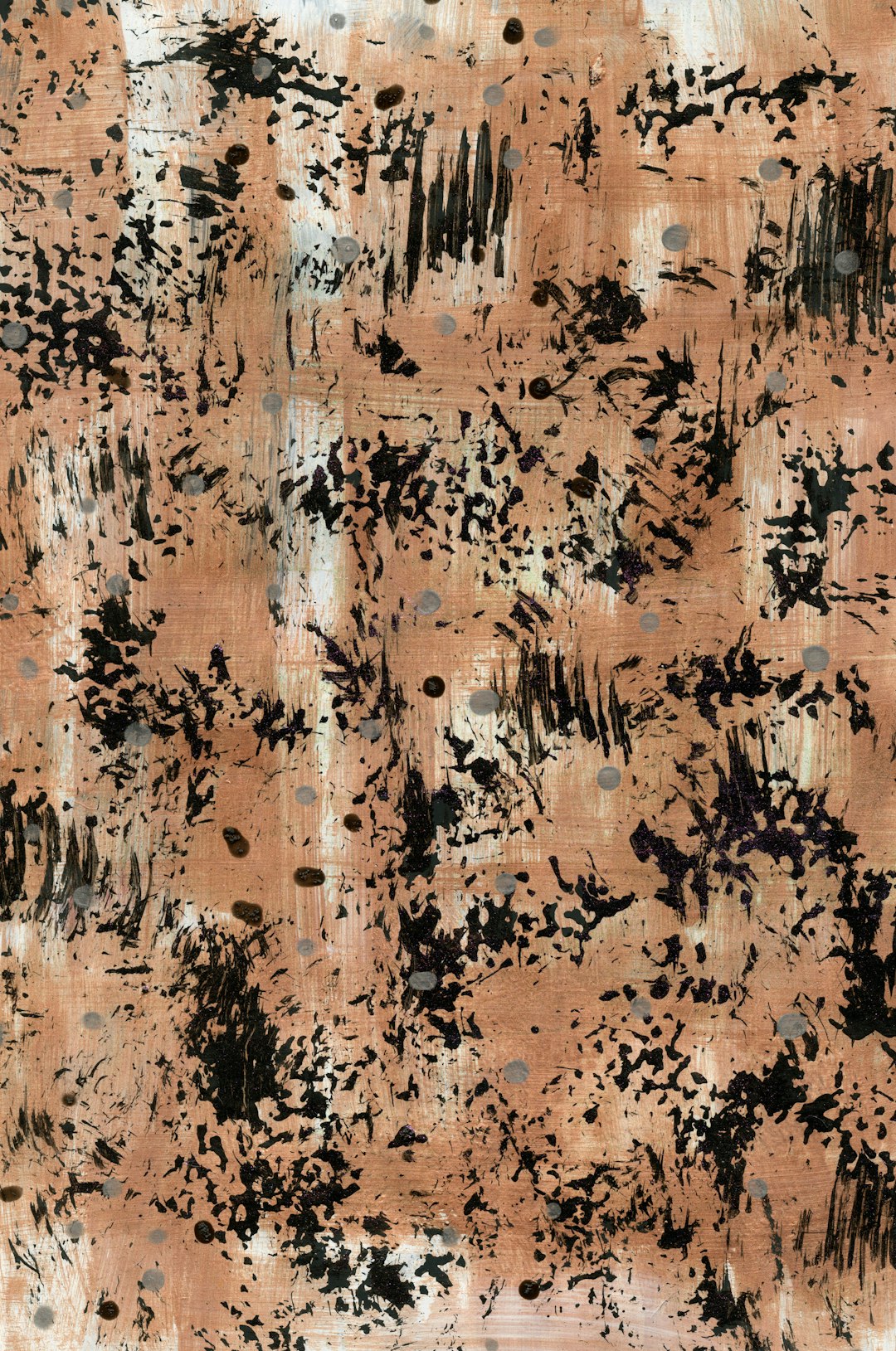 A print with an abstract pattern of small, dark brown and black ink splashes on a light pinkish beige fabric. The background is a solid muted color. –ar 21:32