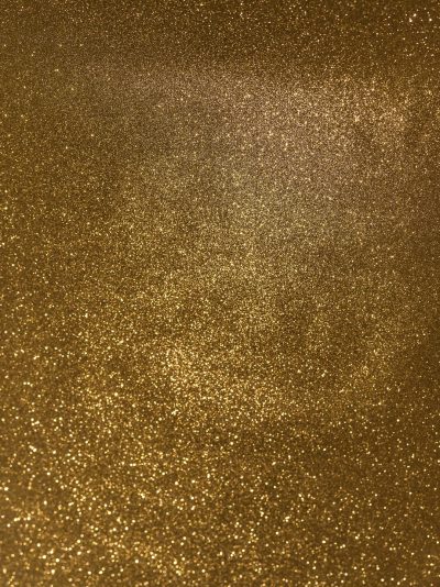 A photo of a gold glitter texture, with a uniform and dense pattern. The background is a solid color. --ar 95:128