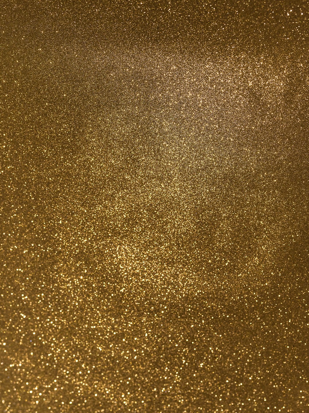 A photo of a gold glitter texture, with a uniform and dense pattern. The background is a solid color. –ar 95:128