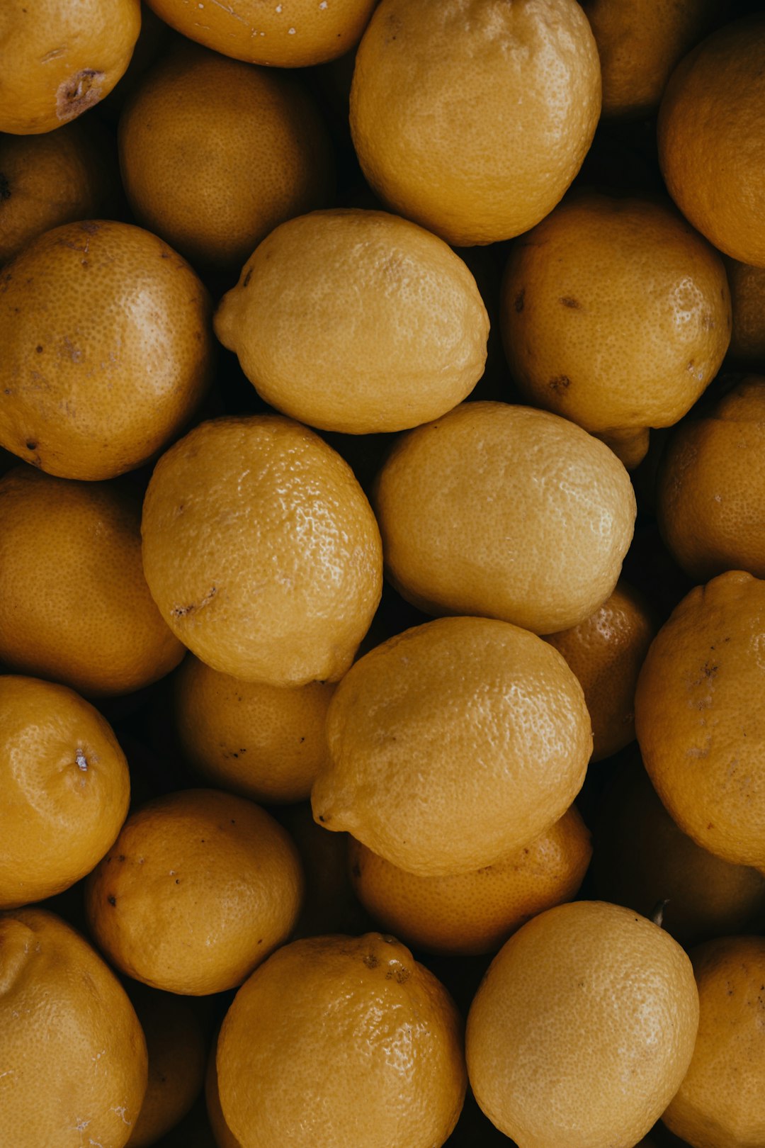 A pile of lemons, close-up top-down view, food photography, in the style of Unsplash. –ar 85:128