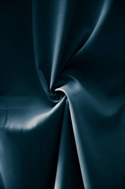 A dark teal silk fabric, close up, smooth and shiny, in a studio setting with soft lighting, captured in the style of photographer [Rineke Dijkstra](https://goo.gl/search?artist%20Rineke%20Dijkstra). --ar 85:128