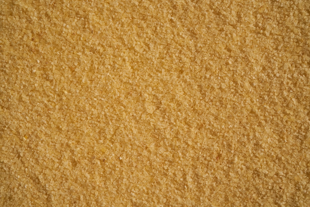 A top view of golden brown sugar, textured background, no shadows, no text, no logo, no letters, no word mark, no typography, no shading –ar 128:85