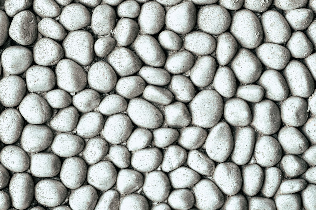 White pebbles, seamless texture background, top view. grey stones surface. stone wall or floor decoration –ar 128:85