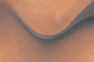 top view of sand dunes, smooth lines, orange and grey, abstract, realistic photography, high resolution, hyperrealistic, detailed --ar 128:85