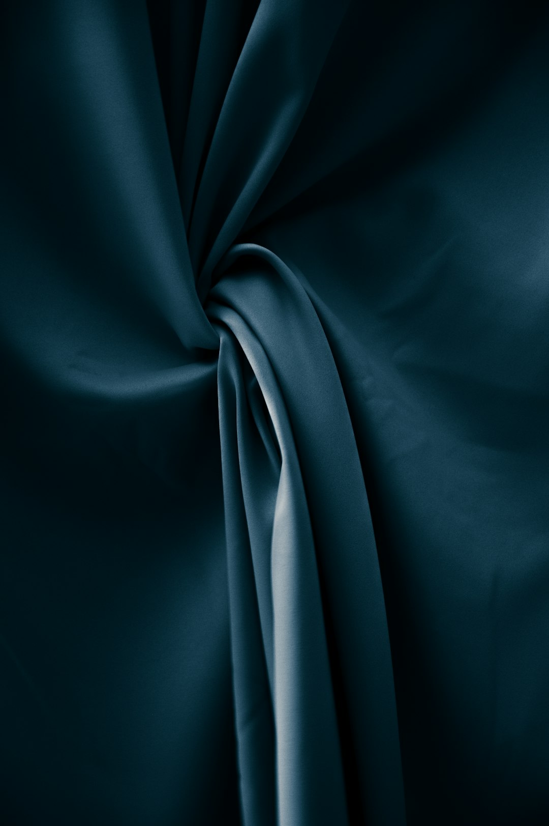 a dark teal silk fabric, with drapery and folds, against black background, high resolution, studio lighting, high quality photo, pro color grading, soft shadows, no contrast, clean sharp focus –ar 85:128