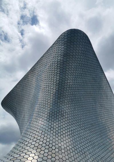 Exterior view of the [Zaha Hadid](https://goo.gl/search?artist%20Zaha%20Hadid) Museum for Contemporary Art in Mexico City, exterior shot, close up shot of its metal surface covered with tiny hexagonal shapes in the style of [Zaha Hadid](https://goo.gl/search?artist%20Zaha%20Hadid), cloudy sky, architectural photography. --ar 45:64