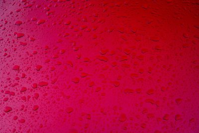 Red background with water droplets, top view, pink red gradient background, closeup of the surface of car body parts, textured and patterned, bright colors, delicate texture, water drops on glass windows, highdefinition photography, wideangle lens, natural light, static composition. --ar 128:85