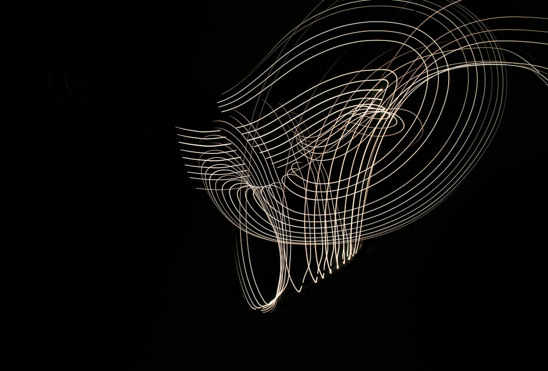 abstract light painting, white lines on black background, the outline of an animal head is formed by thin lines of white light, the figure appears to be moving in the air, creating dynamic curves and swirls around it, creating a sense of movement and energy, minimalistic design with simple shapes and soft lighting, creating a serene atmosphere. –ar 64:43