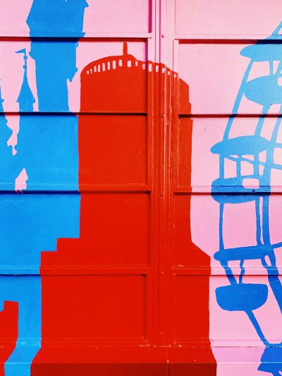 A red, blue and pink wall painted in the style of The tower in London with the silhouette of The tower in London. --ar 3:4